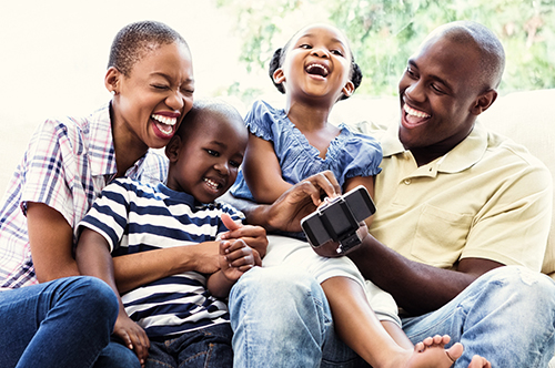 500x332_0011_Happy smiling family on couch Image Text: 500x332_0011_Happy smiling family on couch