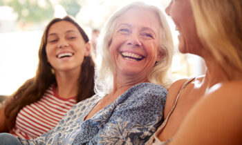 Image Text: 500x332_0024_Mother With Adult Daughter And Teenage Granddaughter Relaxing On Sofa And Talking At Home