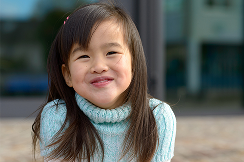 Image Text: 500x332_0059_Friendly little Asian girl with a playful smile