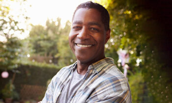 Image Text: Portrait Of Mature Man In Back Yard Garden-690x460